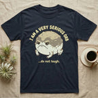 Dark t-shirt with a grumpy toad illustration and text "I am a very serious orb ...do not laugh."