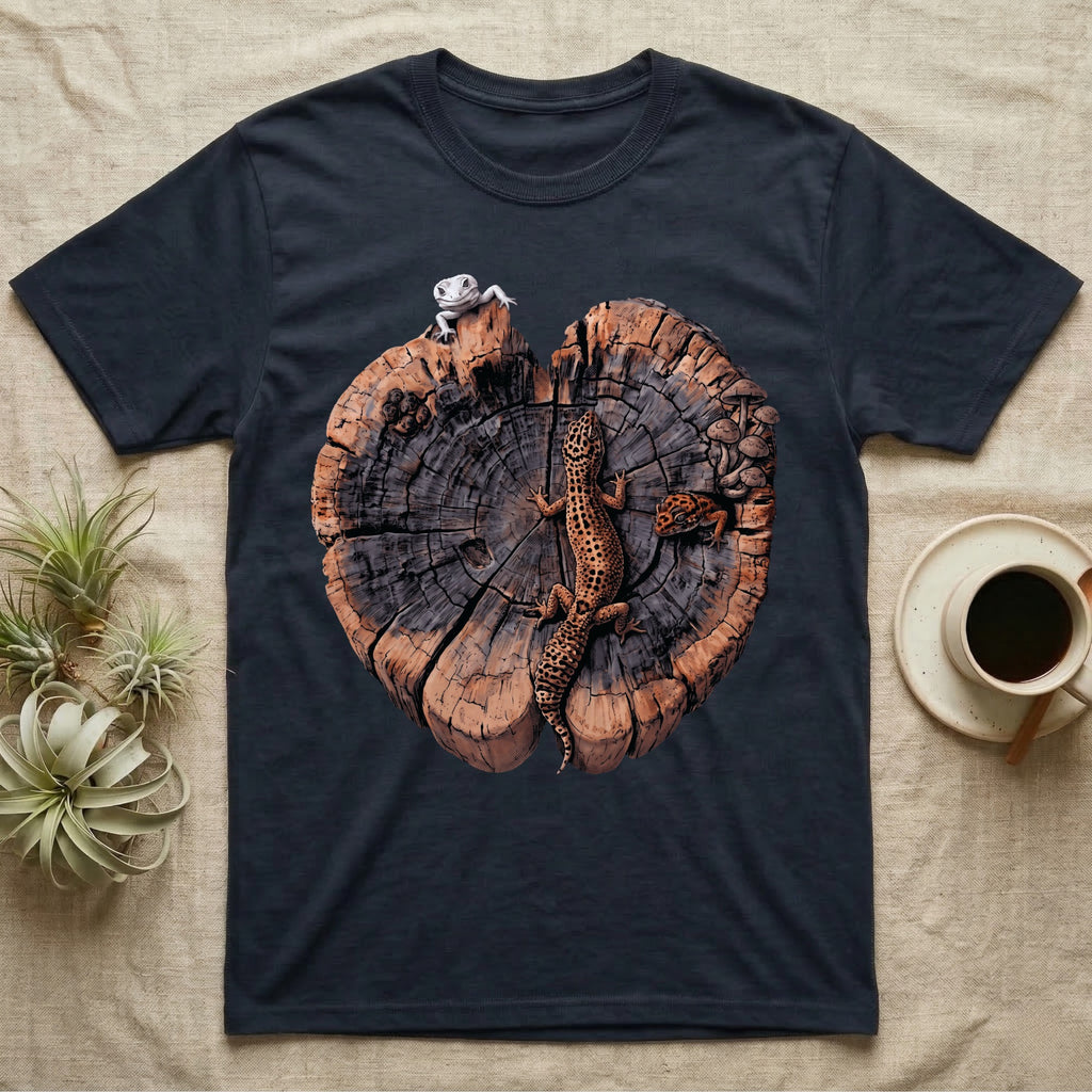 Leopard Gecko Stump Trio T-Shirt in Navy — Three leopard geckos including a leucistic white morph on a cross-section log slab of amber growth rings with mushrooms, no on-shirt text.