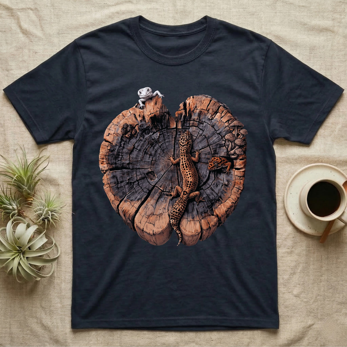 Leopard Gecko Stump Trio T-Shirt in Navy — Three leopard geckos including a leucistic white morph on a cross-section log slab of amber growth rings with mushrooms, no on-shirt text.