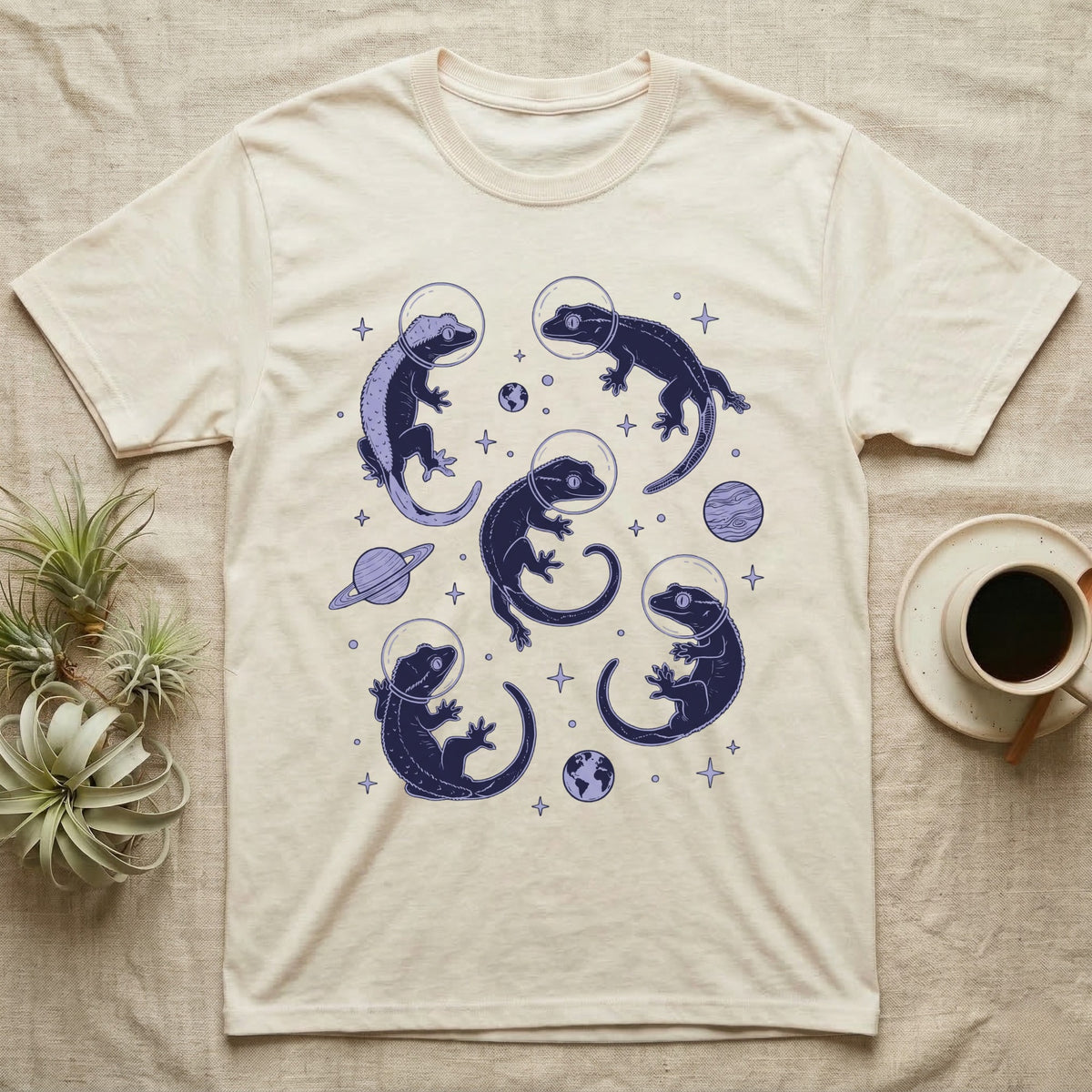 Crested Gecko Cosmic T-Shirt in Natural — Vintage screen-print illustration of crested geckos in astronaut helmets floating in space, deep cosmic indigo monochromatic on dark background.