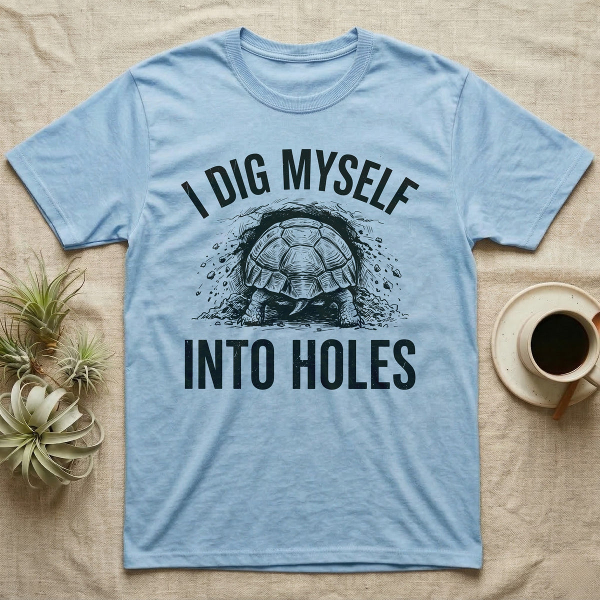 Russian Tortoise Digging T-Shirt in Light Blue — Etched Russian tortoise digging headfirst into an earth bank, only its back end out, with the words I Dig Myself Into Holes