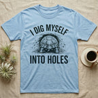 Russian Tortoise Digging T-Shirt in Light Blue — Etched Russian tortoise digging headfirst into an earth bank, only its back end out, with the words I Dig Myself Into Holes