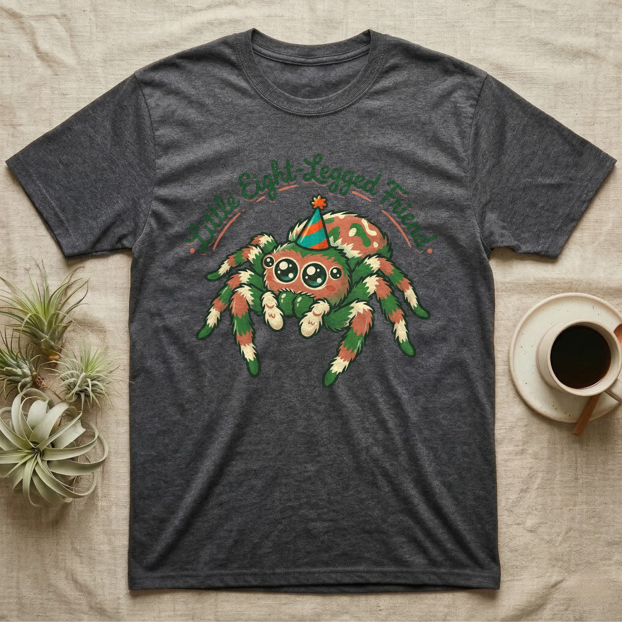 Dark grey t-shirt with a colorful cartoon spider wearing a party hat.