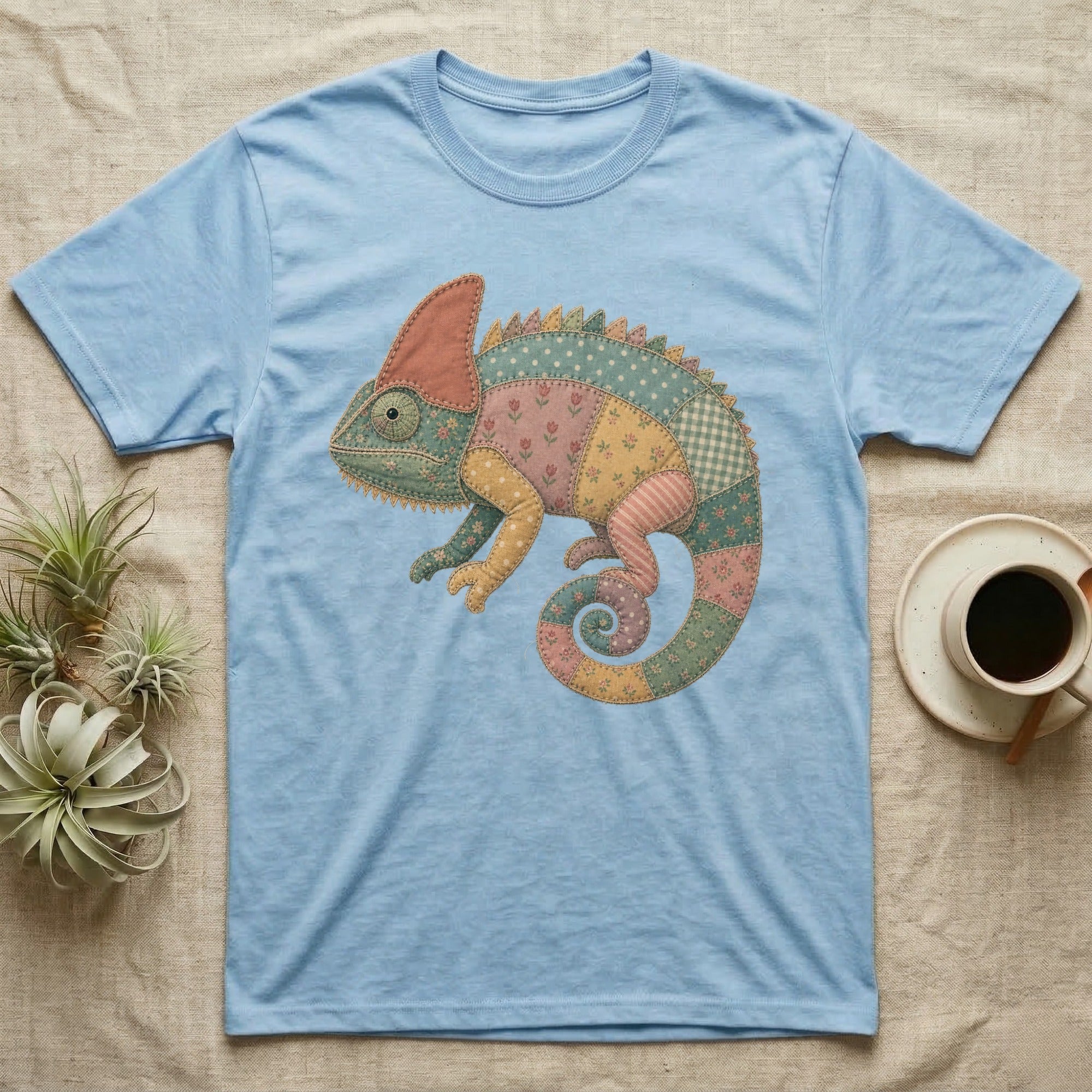 Light blue t-shirt with a colorful patchwork chameleon graphic.