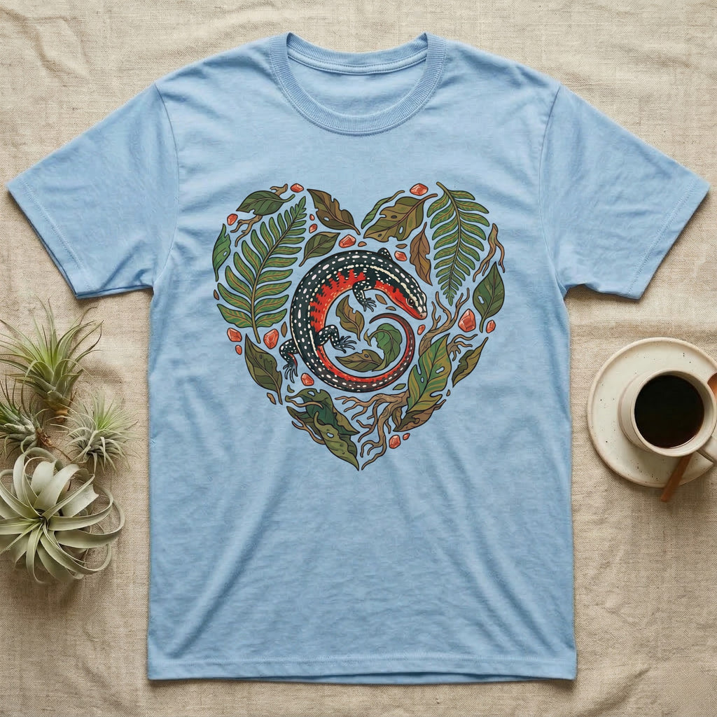 Light blue t-shirt with a heart-shaped design of a lizard and foliage.