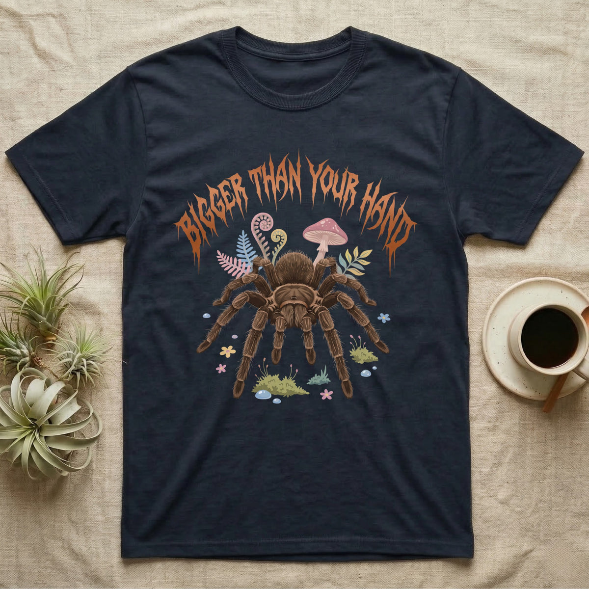 Goliath Birdeater Feral T-Shirt in Navy — Goliath birdeater tarantula with bristly legs spread under jagged copper metal text BIGGER THAN YOUR HAND