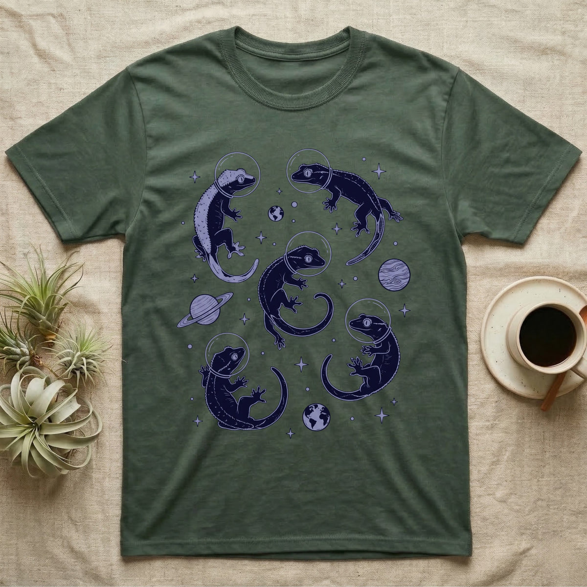 Crested Gecko Cosmic T-Shirt in Military Green — Vintage screen-print illustration of crested geckos in astronaut helmets floating in space, deep cosmic indigo monochromatic on dark background.
