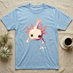 Cute chibi illustration of a smiling cream and coral-pink axolotl floating with splashing water droplets, no on-shirt text. — shown on a Light Blue tee.