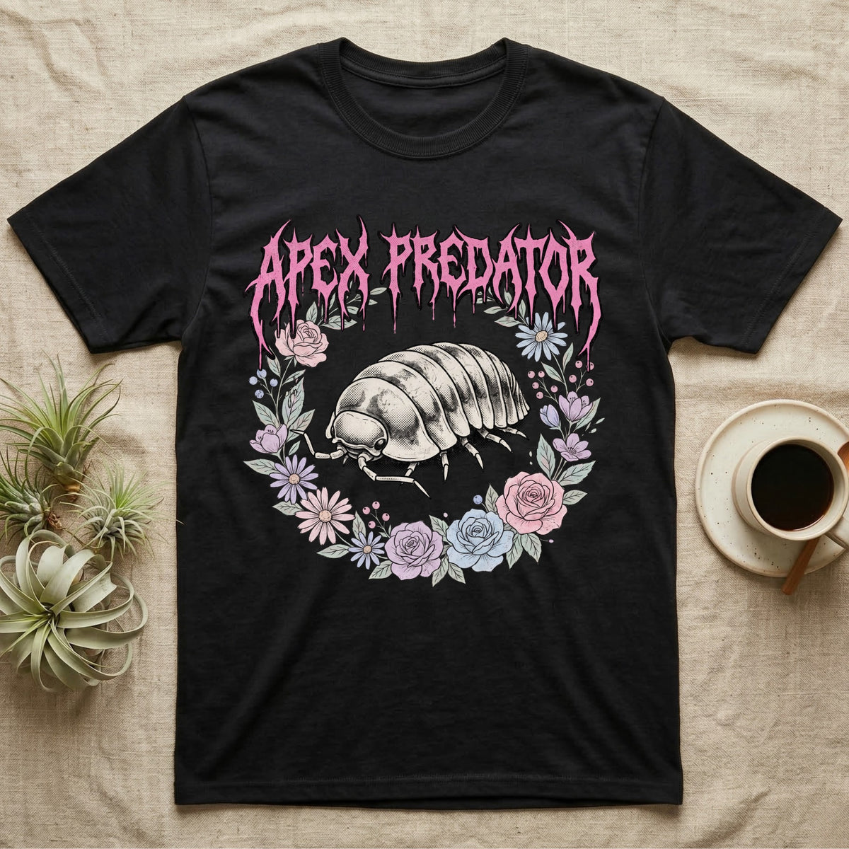 Apex Predator Isopod T-Shirt in Black — Bootleg design of a cute isopod in a floral wreath under dripping death-metal lettering reading "Apex Predator."
