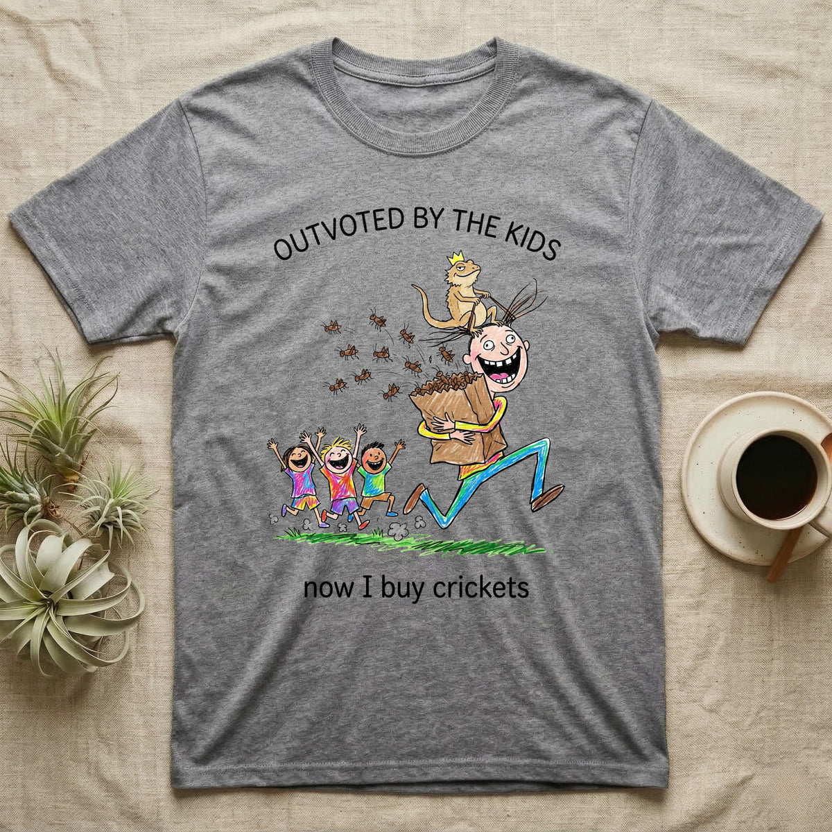 Lizard Dad Outvoted T-Shirt in Sport Grey — Crayon drawing of a crowned bearded dragon riding a grinning dad who carries a bag of crickets while three kids cheer, under Outvoted By The Kids, now I buy crickets
