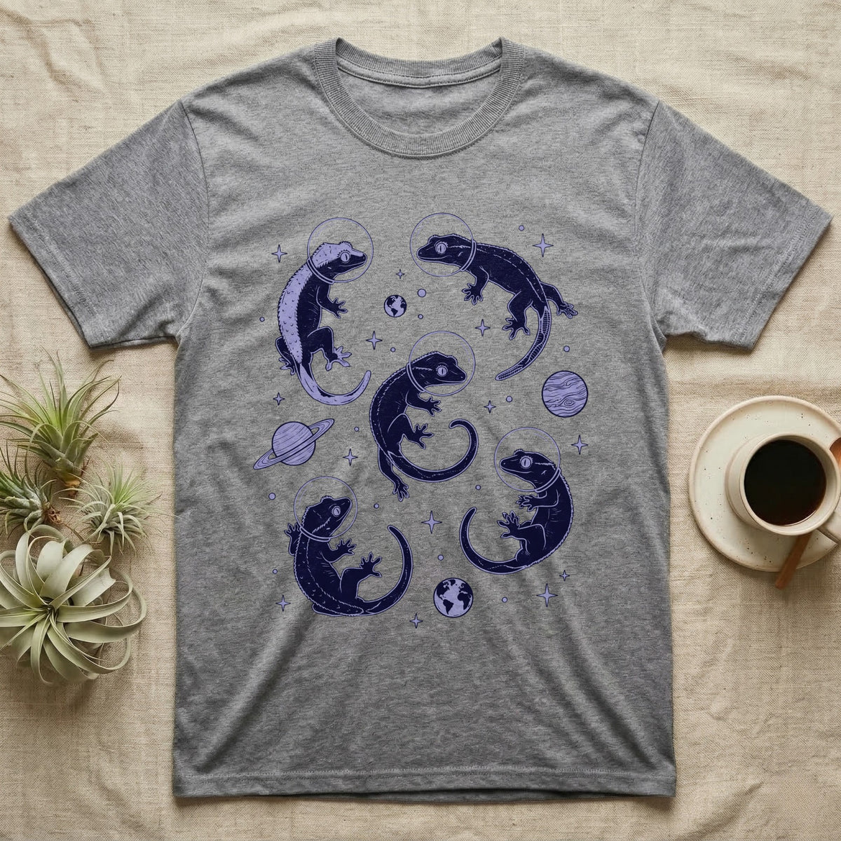 Crested Gecko Cosmic T-Shirt in Sport Grey — Vintage screen-print illustration of crested geckos in astronaut helmets floating in space, deep cosmic indigo monochromatic on dark background.