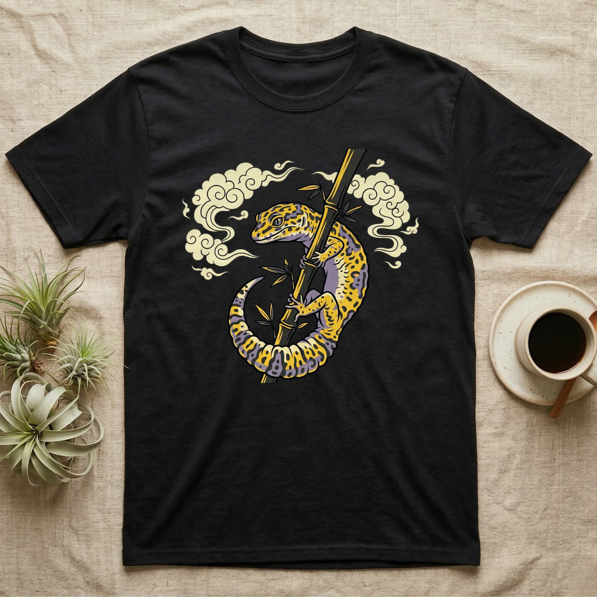 Black t-shirt with leopard gecko on bamboo and clouds graphic.