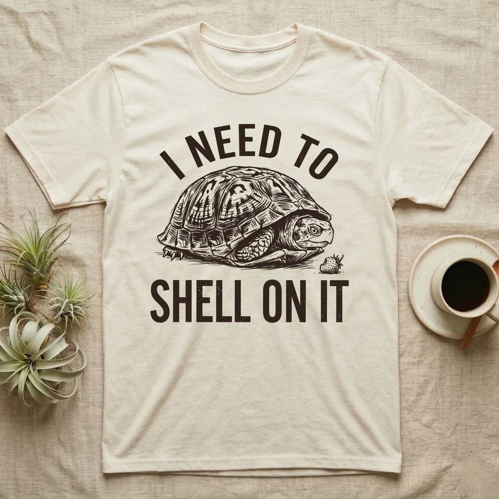 Box Turtle Overthinker T-Shirt in Natural — Etching of a box turtle half-closed in its shell beside a strawberry, under I NEED TO, above SHELL ON IT