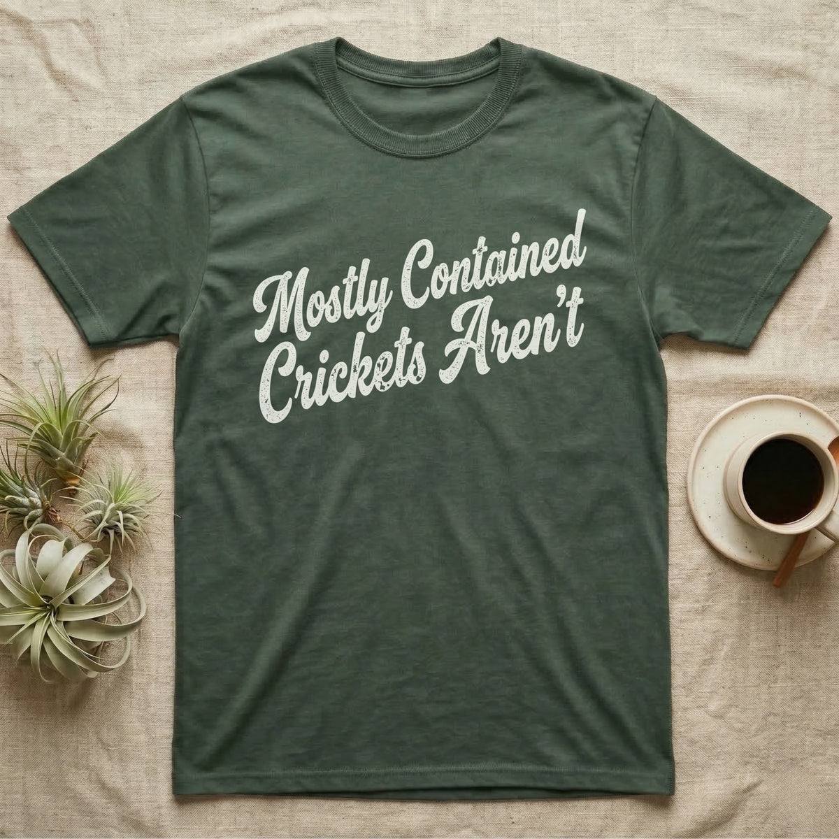 Reptile Cricket Escape T-Shirt in Military Green — Distressed off-white 1970s brush script reading Mostly Contained, Crickets Aren't, climbing a diagonal on charcoal grey