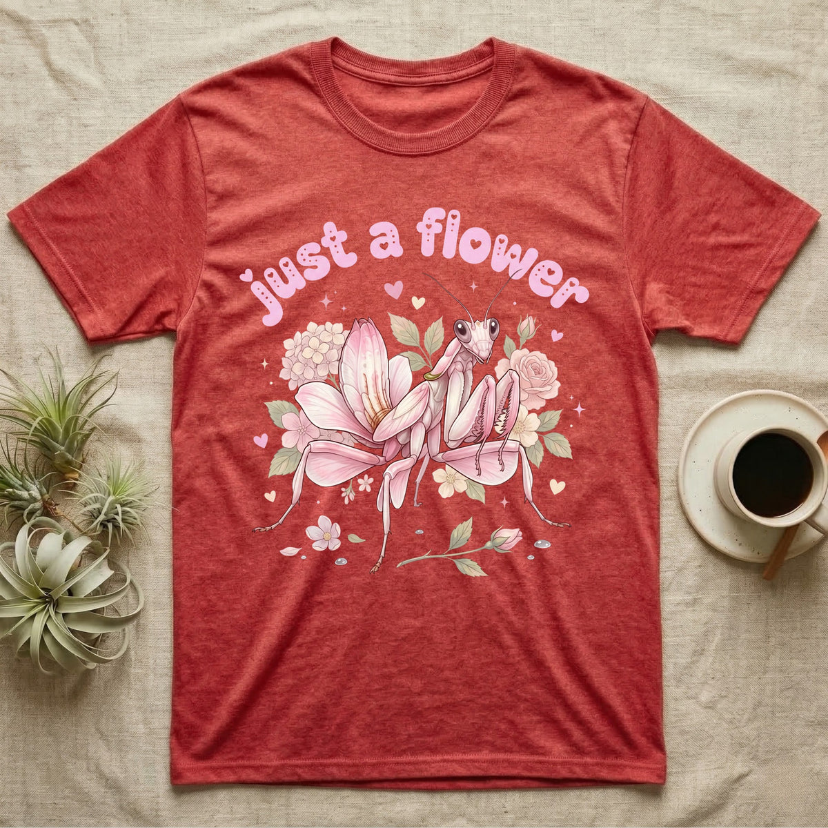 Orchid Mantis Softie T-Shirt in Heather Red — Pink orchid mantis mimicking a flower under pastel bubble text "just a flower" with tiny hearts.