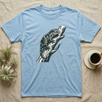 Light blue t-shirt with a black and white lizard graphic on a tree branch.