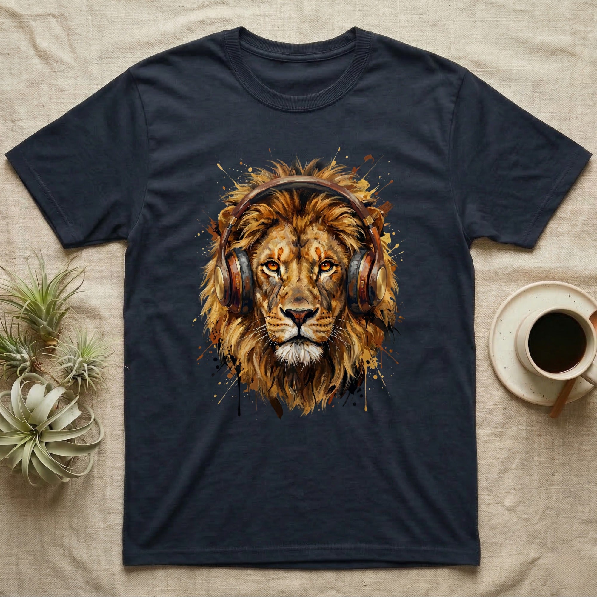 Lion wearing headphones with paint splatters on dark t-shirt.