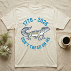Leopard Gecko 1776 T-Shirt in Natural — Two-colour vector leopard gecko in profile ringed by arched text reading 1776 to 2026 and Don't Tread On Me.