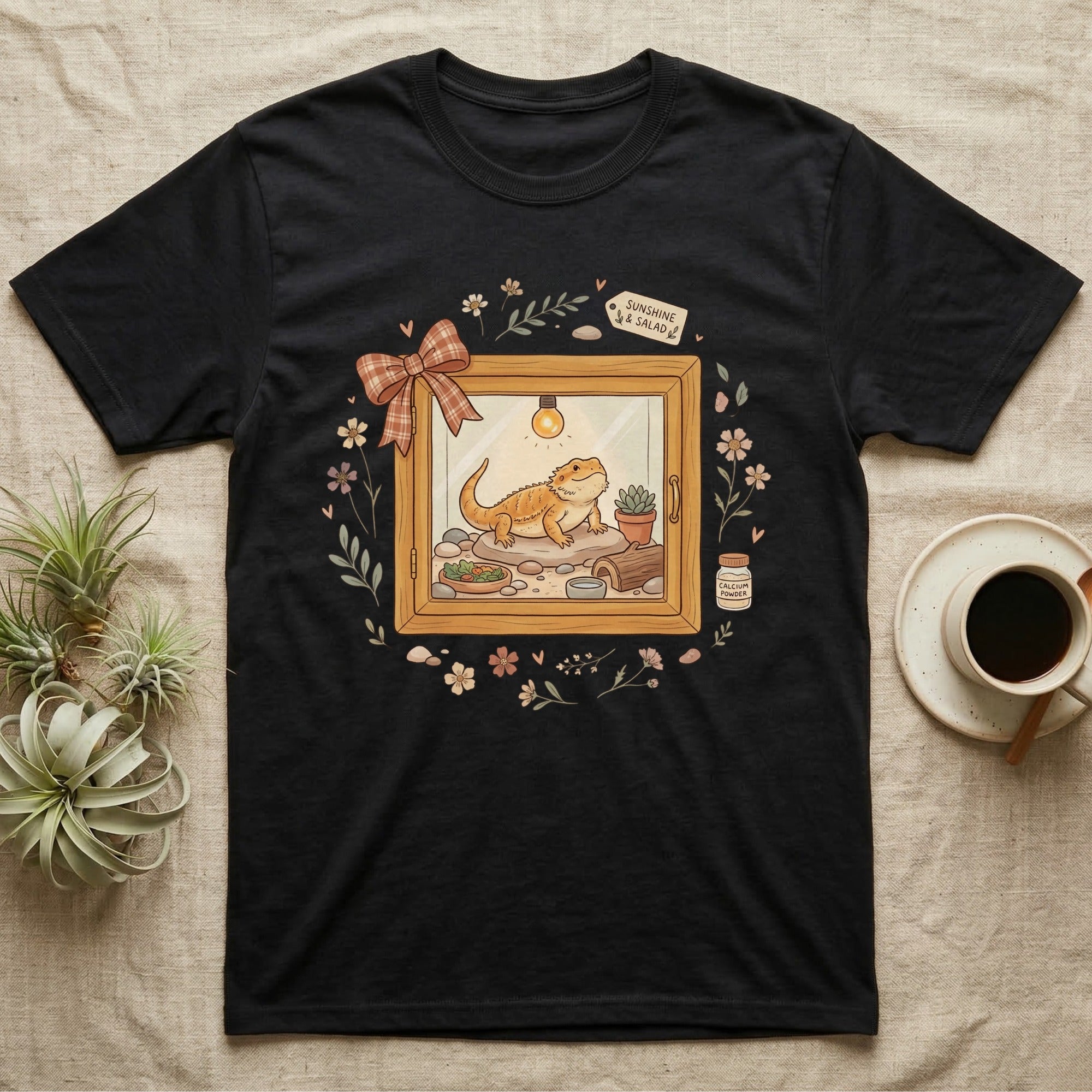 Black t-shirt with bearded dragon enclosure graphic and coffee.