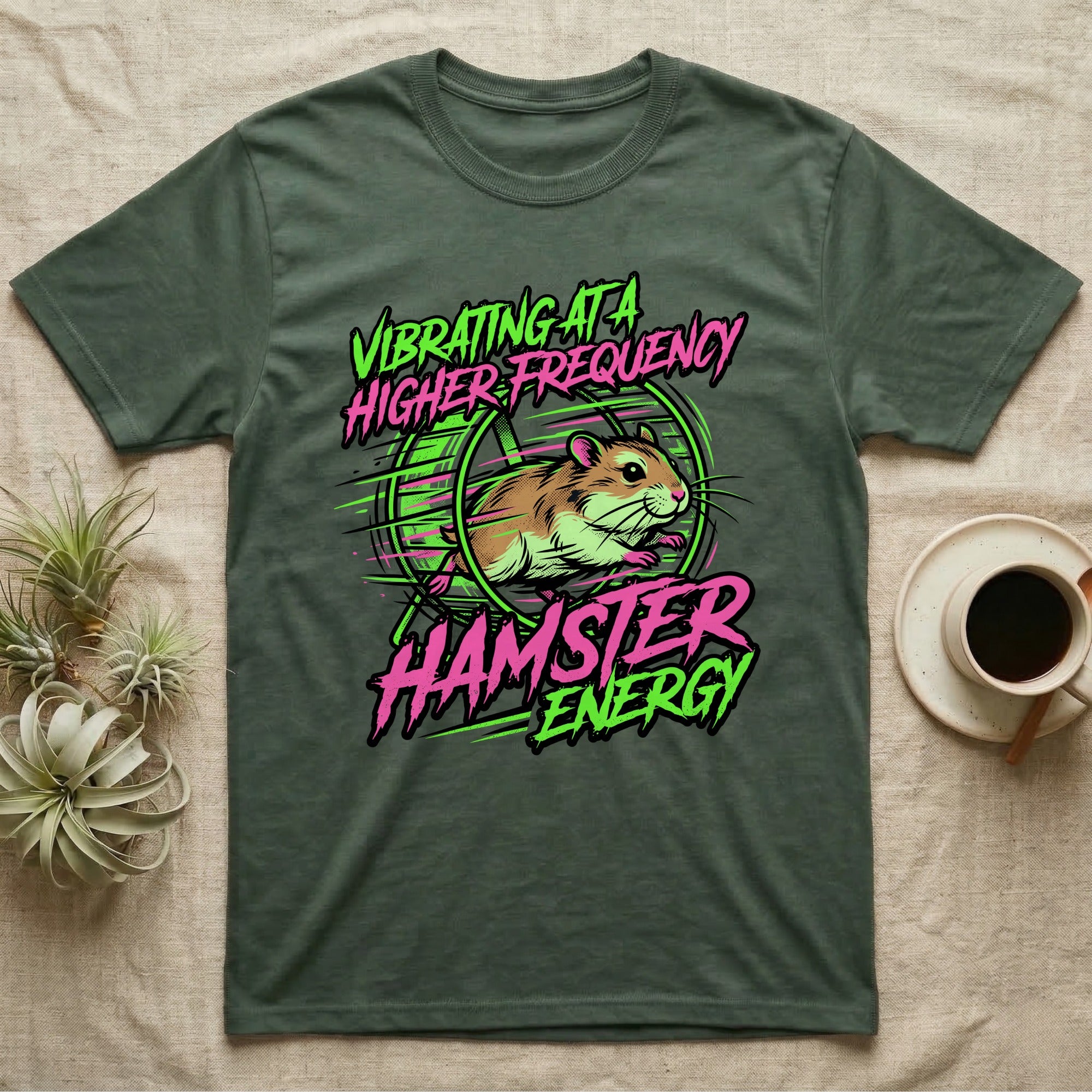 Green t-shirt with "Vibrating at a Higher Frequency Hamster Energy" slogan and cartoon hamster.