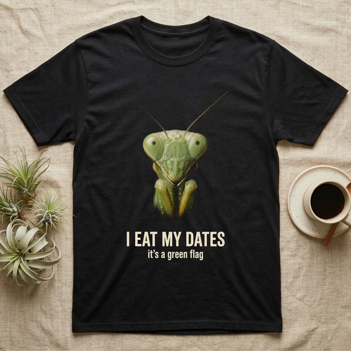 Deadpan macro mugshot of a green praying mantis on black, captioned I eat my dates, it's a green flag. — shown on a Black tee.