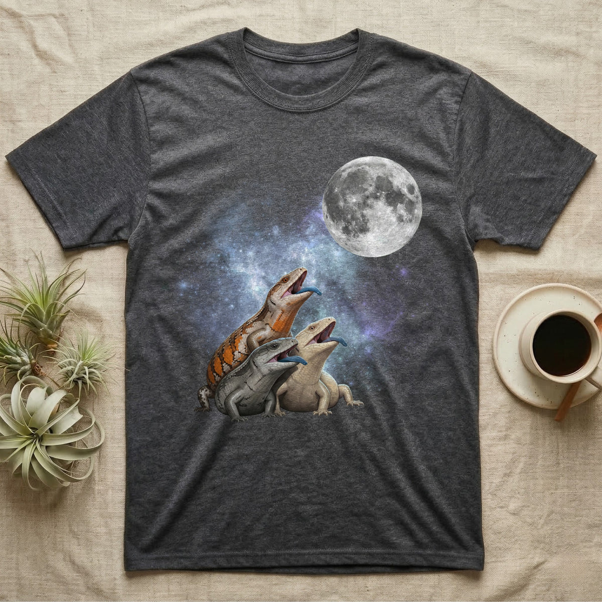 Blue-Tongued Skink Moon Howl T-Shirt in Dark Heather — Three Blue-Tongued Skink colour morphs howling at a full moon over a nebula on a dark grey t-shirt.