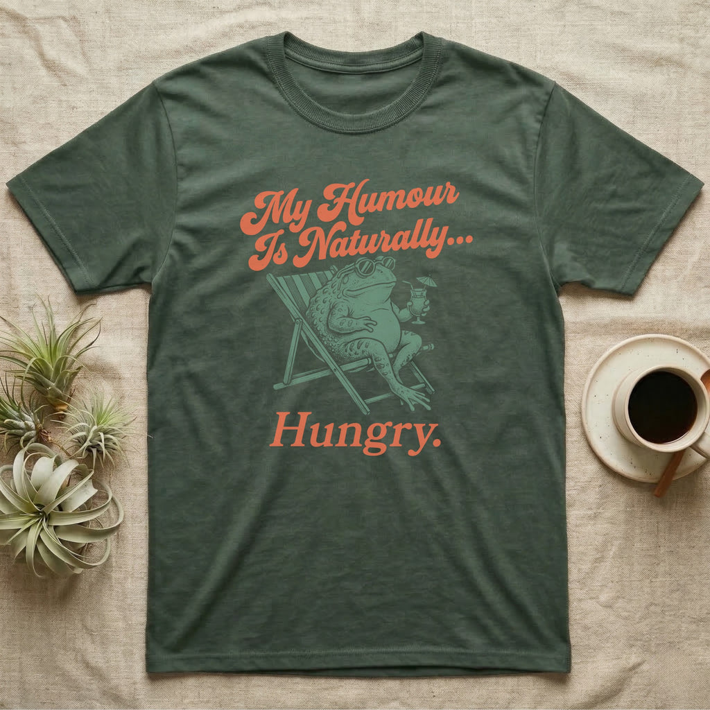 African Bullfrog Sun Lounger T-Shirt in Military Green — Illustrated African bullfrog reclining in a beach chair with sunglasses and a cocktail, retro coral script reading My Humour Is Naturally Hungry.