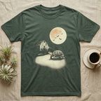 Box Turtle Moonlight T-Shirt in Military Green — An eastern box turtle mid-step across a moonlit yard, a derelict barn behind it and a large cream moon high right.