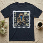 Dark t-shirt with a postage stamp design featuring a lizard and "USA Postage 37 Cents".