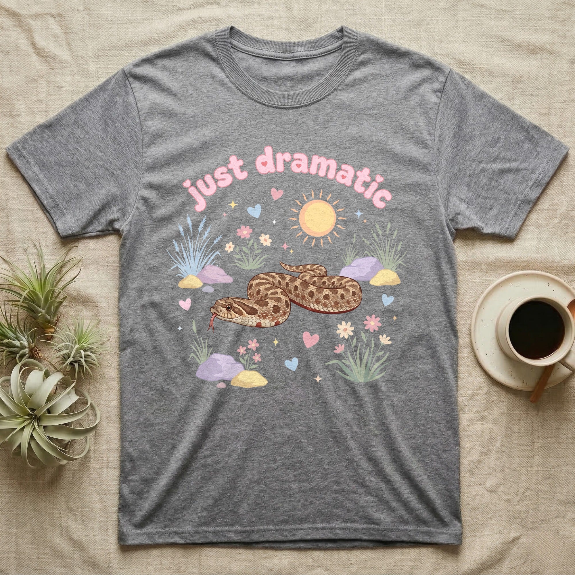 Western Hognose Snake Baby T-Shirt in Sport Grey — Pastel western hognose snake in a low coil with tongue out among grasses, puffy pink bubble wordmark "just dramatic" above.