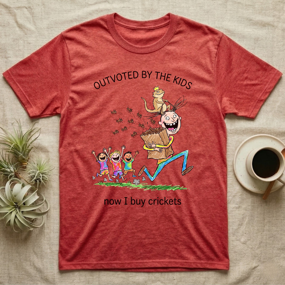 Lizard Dad Outvoted T-Shirt in Heather Red — Crayon drawing of a crowned bearded dragon riding a grinning dad who carries a bag of crickets while three kids cheer, under Outvoted By The Kids, now I buy crickets