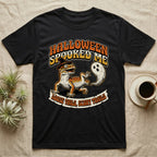 Leopard Gecko Spooked Me T-Shirt in Black — Distressed graphic of a shocked leopard gecko in a witch hat beside its ghost-costumed dropped tail, "Halloween Spooked Me."