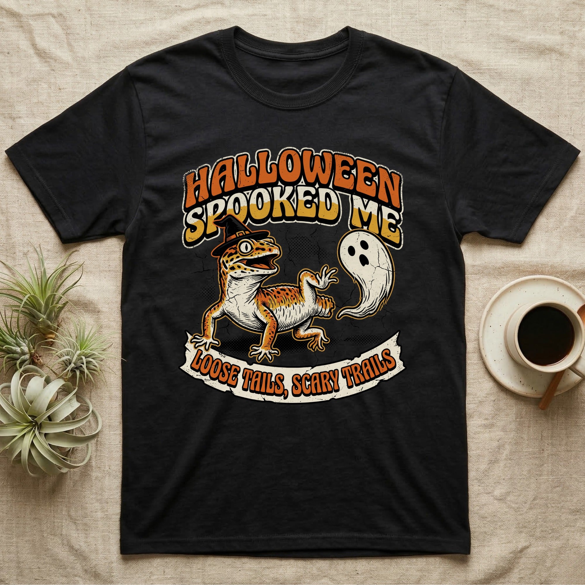 Leopard Gecko Spooked Me T-Shirt in Black — Distressed graphic of a shocked leopard gecko in a witch hat beside its ghost-costumed dropped tail, "Halloween Spooked Me."