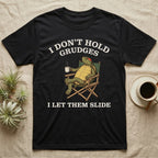 Red-Eared Slider Grudges T-Shirt in Black — Engraved red-eared slider lounging in a camp chair with tea under I Don't Hold Grudges I Let Them Slide