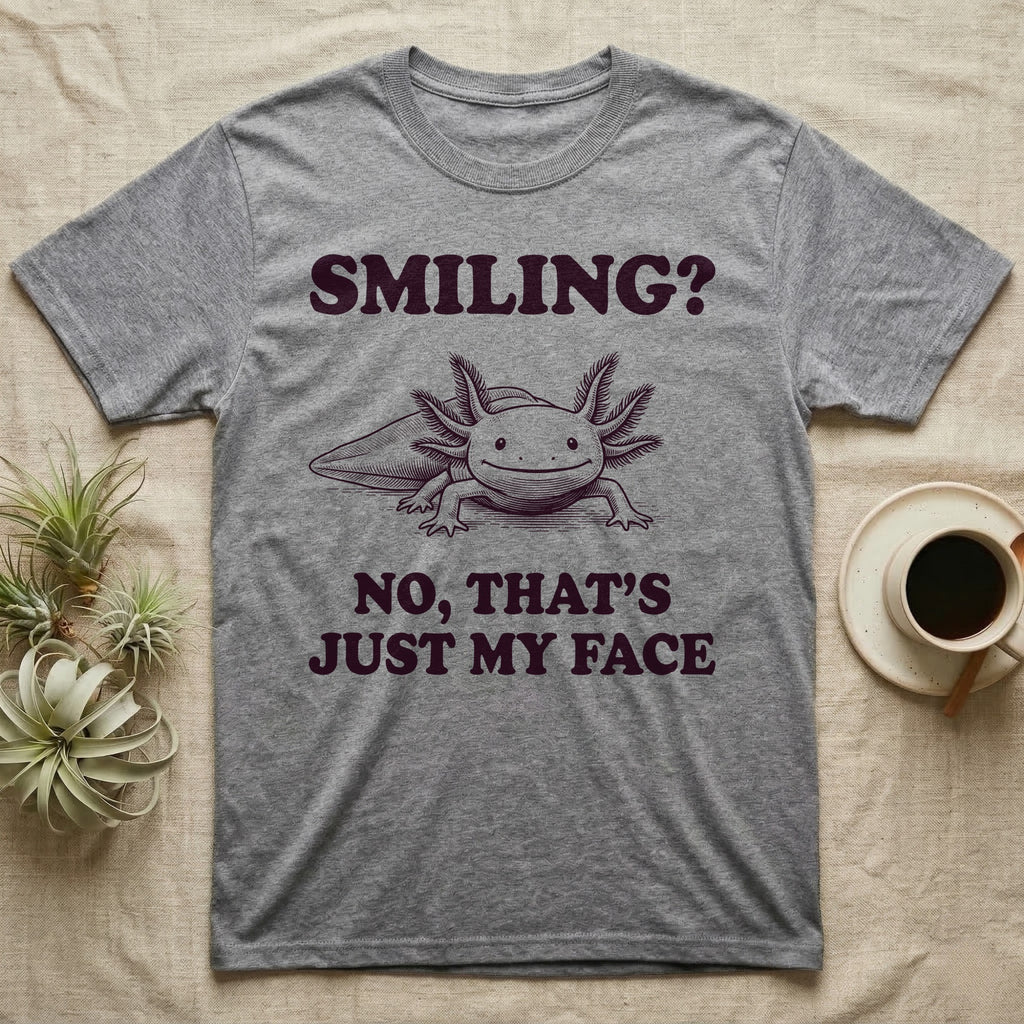 Axolotl Resting Face T-Shirt in Sport Grey — Engraved axolotl sitting head-on with gills fanned and a wide smile, with the words Smiling? No, That's Just My Face