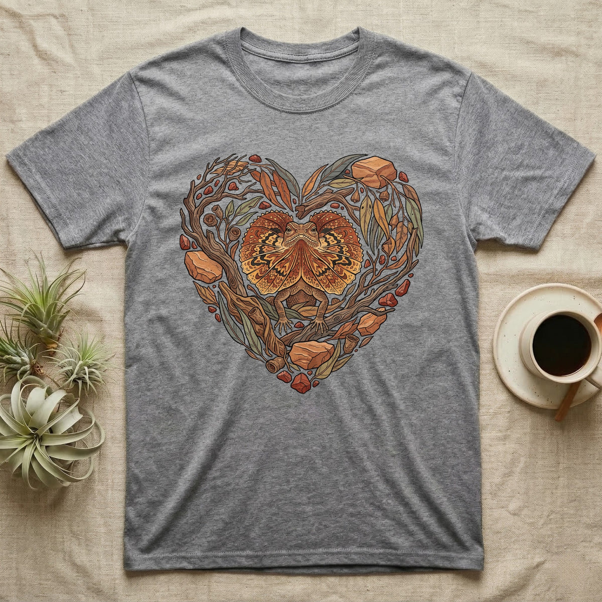 Grey t-shirt with heart-shaped nature design featuring a frilled lizard.