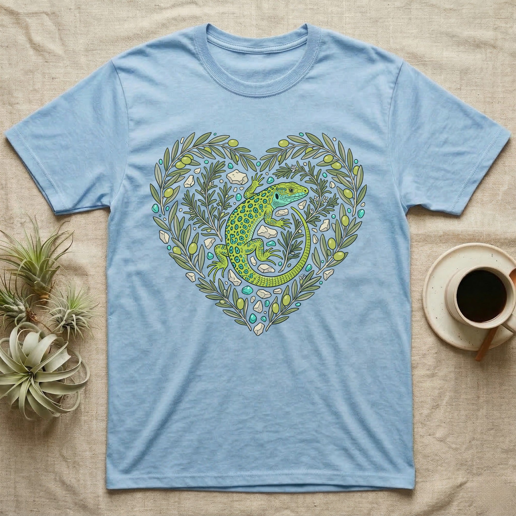 Light blue t-shirt with green lizard and olive branches forming a heart.