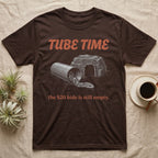 Corn Snake Tube T-Shirt in Dark Chocolate — Engraved corn snake lounging in a cardboard tube beside an empty rock hide, under retro script reading TUBE TIME.