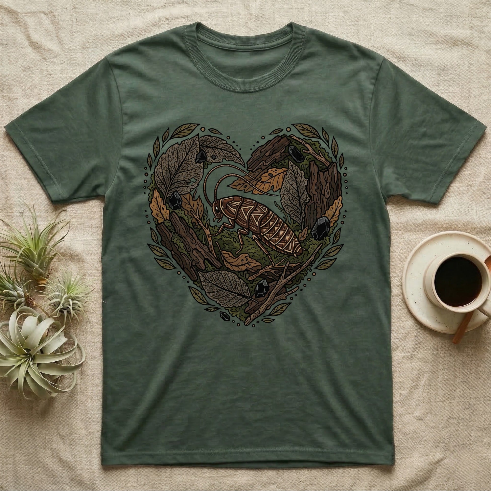 Green t-shirt with a heart-shaped design of a cockroach and forest elements.