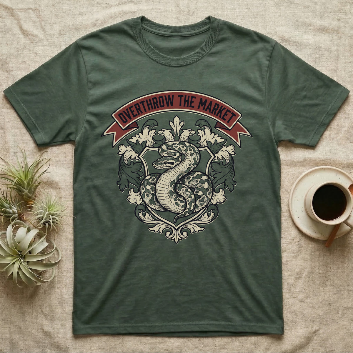 Overthrow The Market Python T-Shirt in Military Green — Vintage heraldic-crest illustration of a regal ball python with a banner reading "Overthrow The Market."