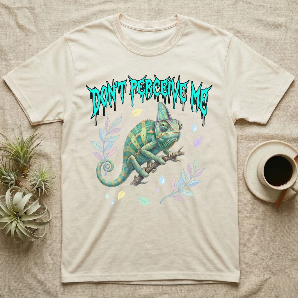 Veiled Chameleon Feral T-Shirt in Natural — Veiled chameleon on a branch with swivelling eyes under a jagged turquoise metal "DON'T PERCEIVE ME" wordmark.