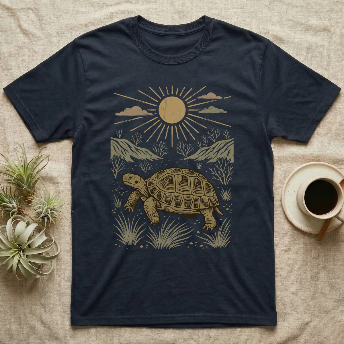 Russian Tortoise Home Range T-Shirt in Navy — Woodcut-style illustration of a Russian tortoise walking across gravelly steppe under a full sun with dry hills behind, no on-shirt text.