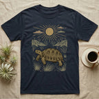 Russian Tortoise Home Range T-Shirt in Navy — Woodcut-style illustration of a Russian tortoise walking across gravelly steppe under a full sun with dry hills behind, no on-shirt text.