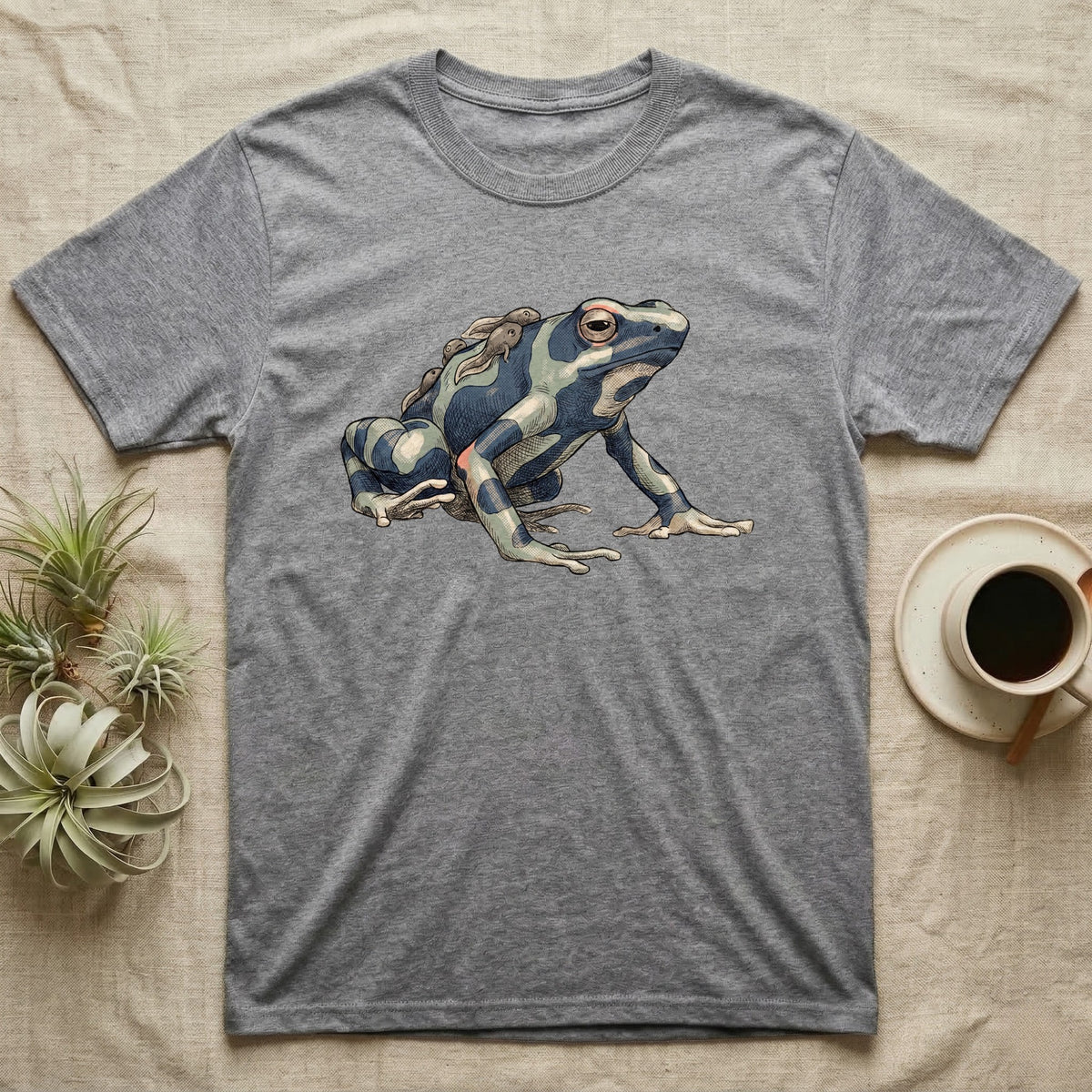 Dart Frog Tadpole T-Shirt in Sport Grey — Naturalist-plate illustration of a dyeing dart frog carrying tadpoles on its back with a dry typewriter caption beside it.