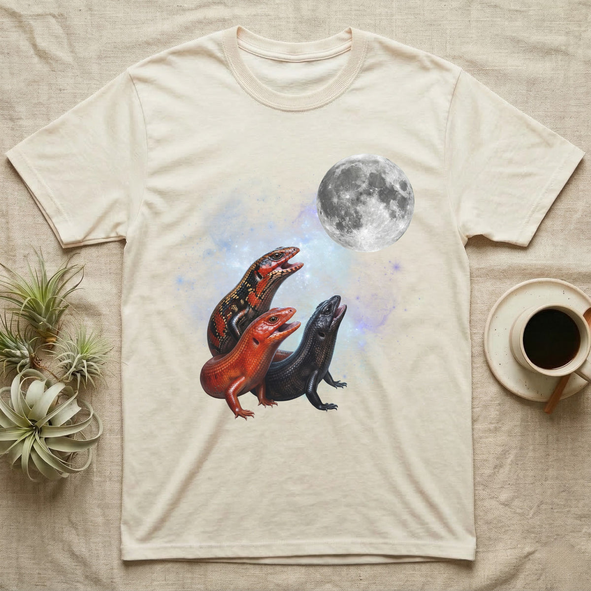 Fire Skink Moon Howl T-Shirt in Natural — Three Fire Skink colour morphs howling at a full moon over a nebula on a dark grey t-shirt.
