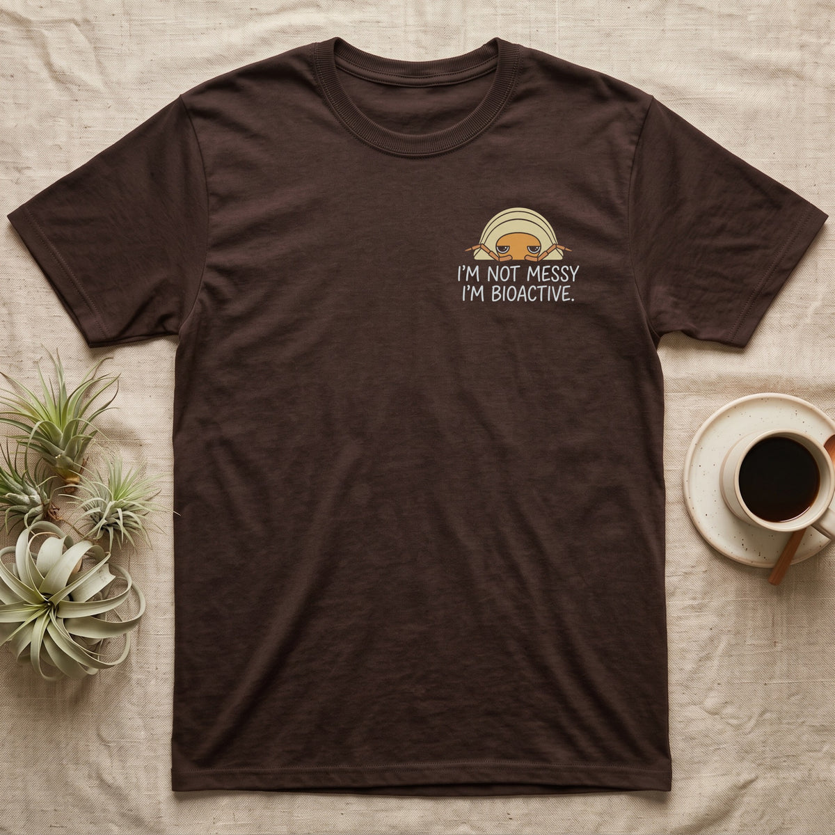 Bioactive Rubber Ducky T-Shirt in Dark Chocolate — Creamy-yellow rubber ducky isopod with an orange face peeking over white marker capitals reading I'M NOT MESSY I'M BIOACTIVE.