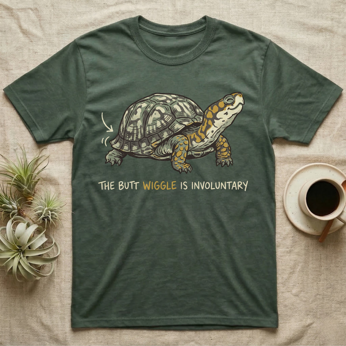 Box Turtle Wiggle T-Shirt in Military Green — Retro-illustration of a box turtle mid shell-scratch with a hand-drawn arrow at its wiggling rear and a deadpan marker caption.