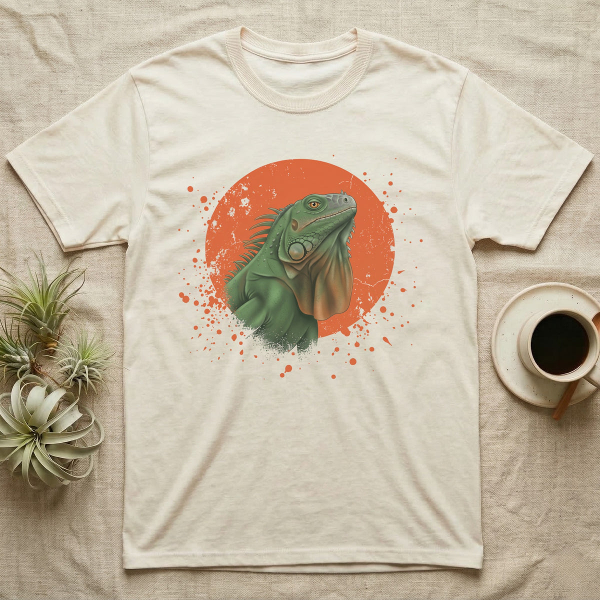 Green Iguana Stink Face T-Shirt in Natural — Distressed vintage-style illustration of a green iguana with its dewlap fully dropped and chin lifted, on an orange disc.
