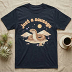 Kenyan Sand Boa Softie T-Shirt in Navy — Kenyan sand boa looping out of pastel sand dunes under a puffy "just a sausage" bubble wordmark with tiny hearts.
