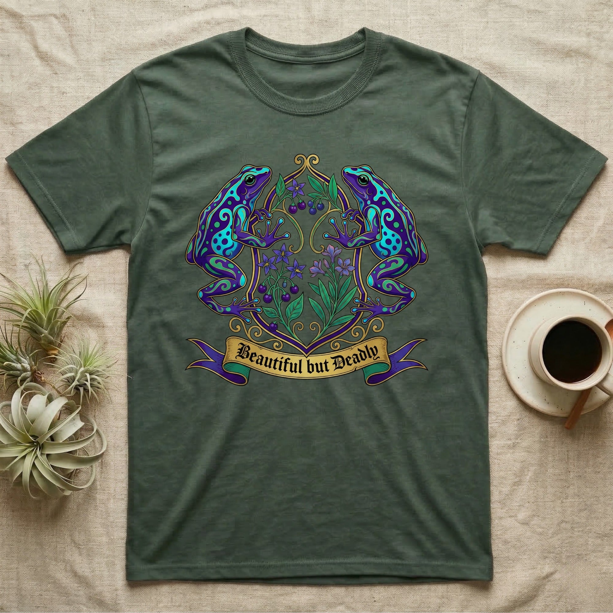Dark green t-shirt with "Beautiful but Deadly" text and two colorful frogs on a floral branch.